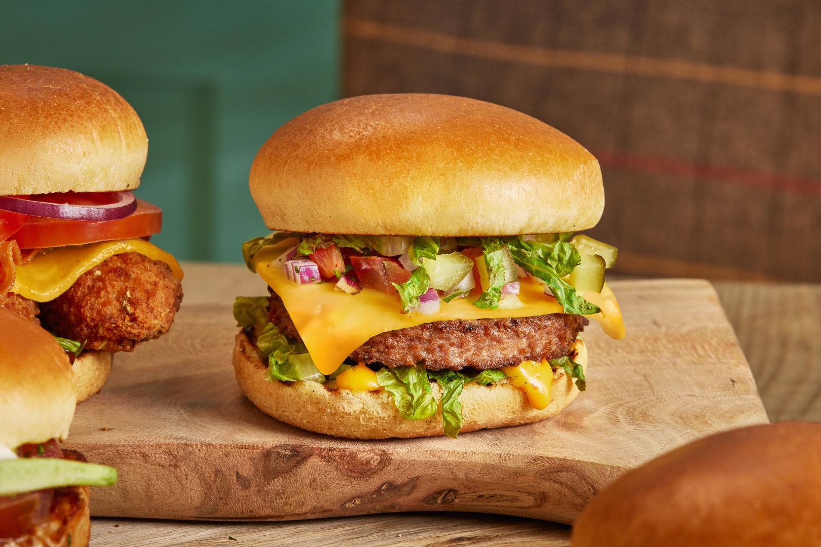 Cookhouse + Pub The Vegan Burger GARDEN GOURMET® Sensational™ burger with a Violife slice, lettuce, gherkin, red onion & burger sauce in a brioche style bun.